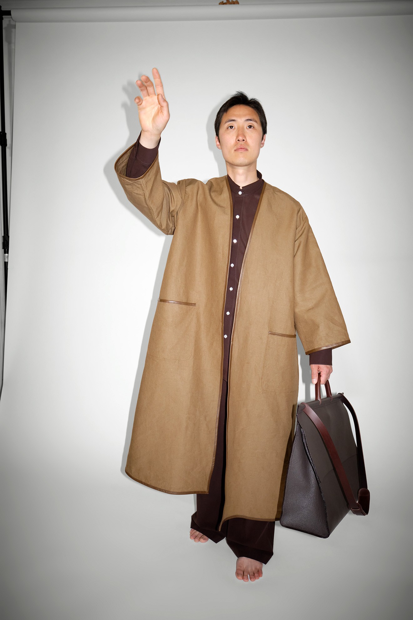 Collarless coat with leather piping